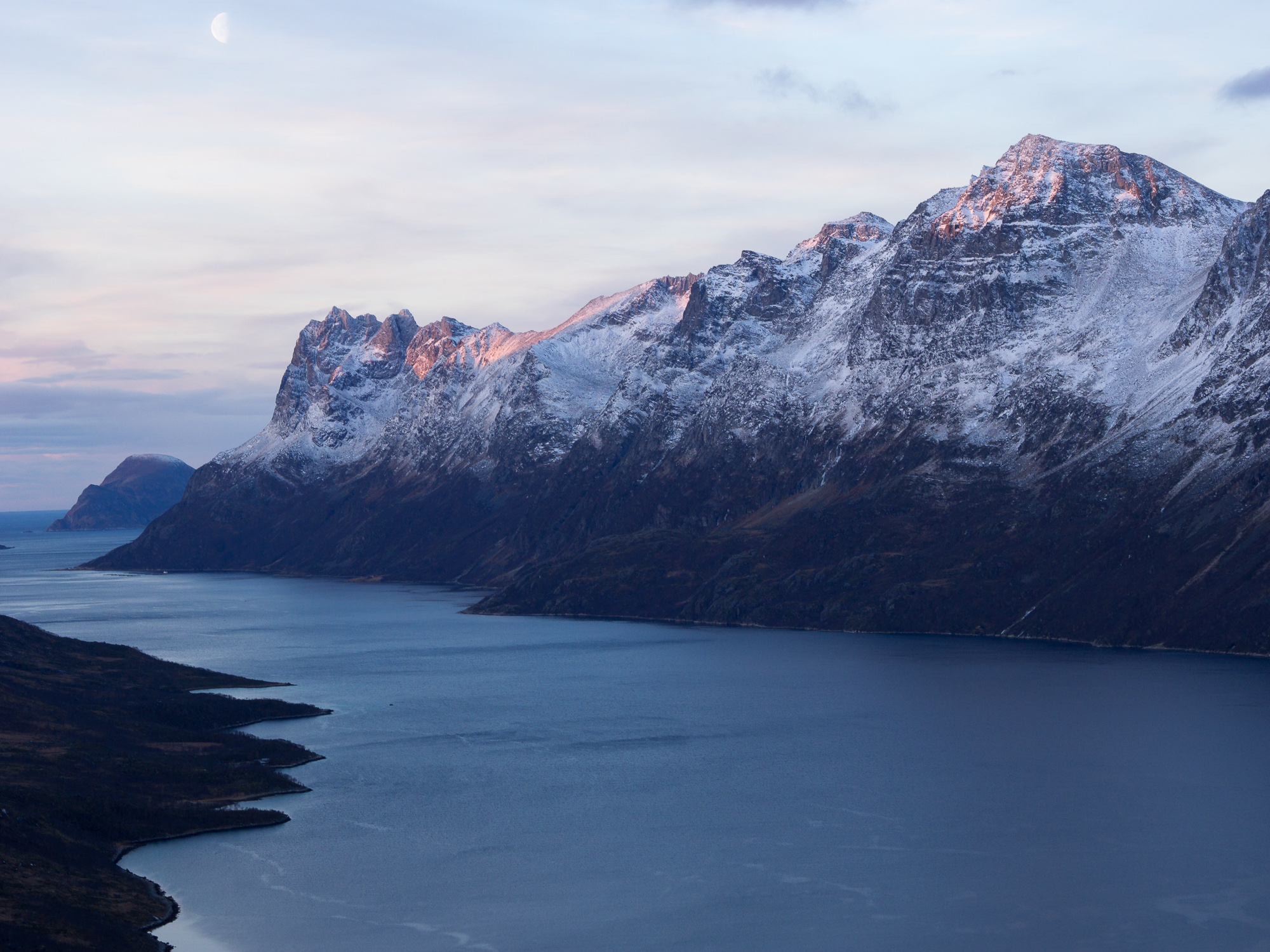 Midday sun shines on the peaks on the other side of Ersfjord.