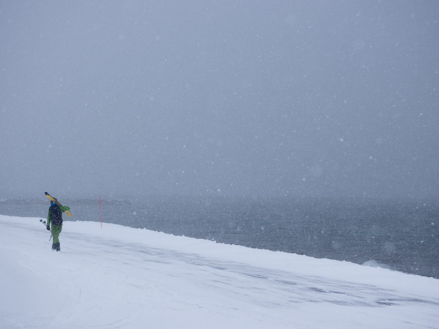 Andrea on a classic Tromsø exit hike, right next to the cold, grey water.